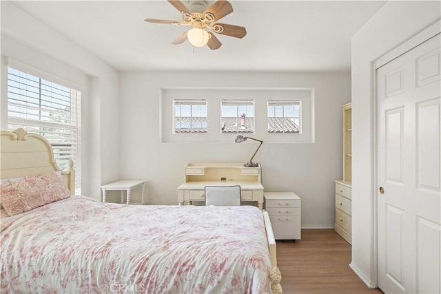 26974 Colonial Ln, Valencia, CA 91355 - bedroom with multiple windows, wood finished floors, baseboards, and ceiling fan