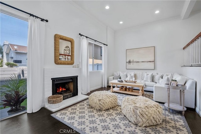 25839 Cypress St Unit B, Lomita, CA 90717 - living room featuring dark wood finished floors, ornamental molding, recessed lighting, a warm lit fireplace, and baseboards