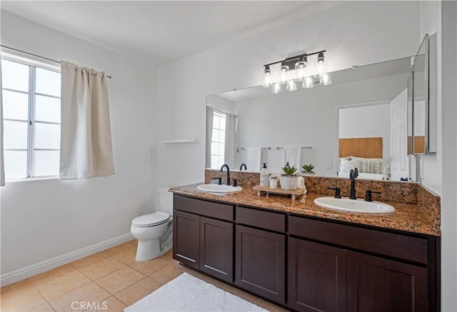 25839 Cypress St Unit B, Lomita, CA 90717 - ensuite bathroom featuring double vanity, tile patterned floors, toilet, and baseboards