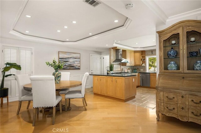 13061 Rosalind Dr, North Tustin, CA 92705 - dining area featuring a tray ceiling, ornamental molding, recessed lighting, light wood-style floors, and a wainscoted wall