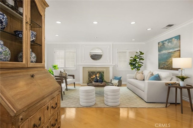 13061 Rosalind Dr, North Tustin, CA 92705 - living room featuring crown molding, light wood-style flooring, recessed lighting, a fireplace, and baseboards