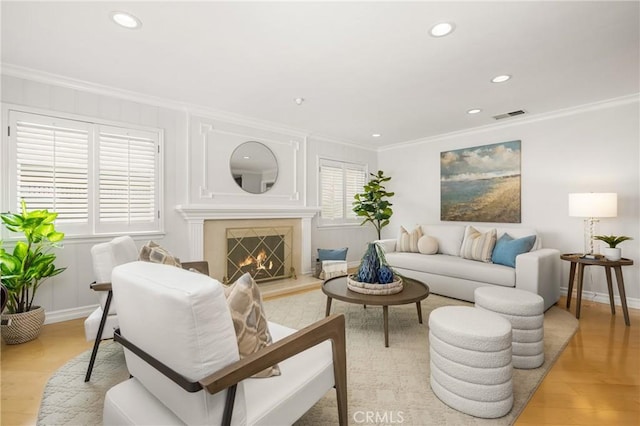 13061 Rosalind Dr, North Tustin, CA 92705 - living room featuring crown molding, light wood-style floors, recessed lighting, baseboards, and a warm lit fireplace