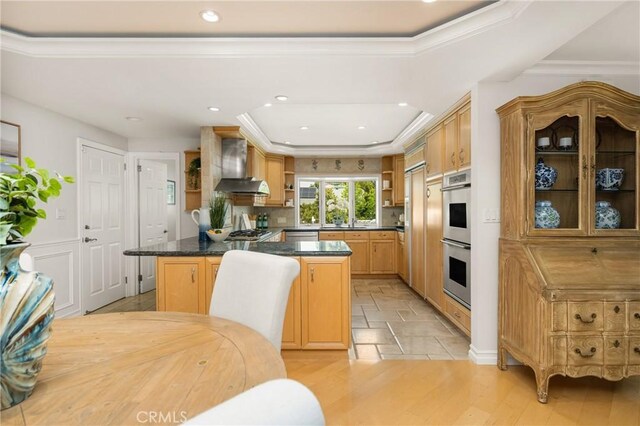 13061 Rosalind Dr, North Tustin, CA 92705 - kitchen with open shelves, wall chimney exhaust hood, stainless steel appliances, dark countertops, and recessed lighting