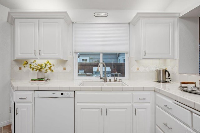 7414 Lantana, Carlsbad, CA 92011 - kitchen with white dishwasher, white cabinets, and tasteful backsplash