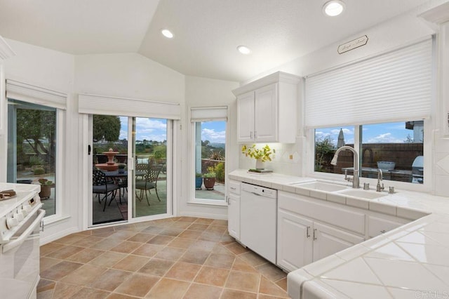 7414 Lantana, Carlsbad, CA 92011 - kitchen featuring tile countertops, range, white dishwasher, lofted ceiling, and white cabinets