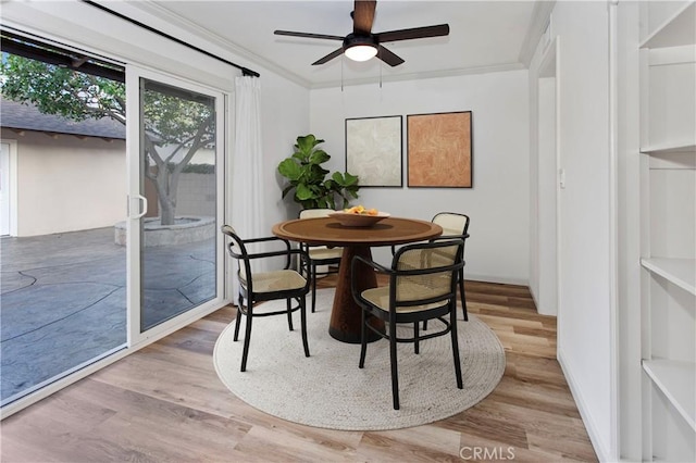 7710 Shoup Ave, West Hills, CA 91304 - dining space with wood finished floors, ceiling fan, and ornamental molding