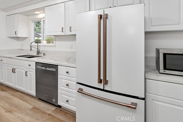 7710 Shoup Ave, West Hills, CA 91304 - kitchen with appliances with stainless steel finishes, white cabinets, a sink, and light wood finished floors