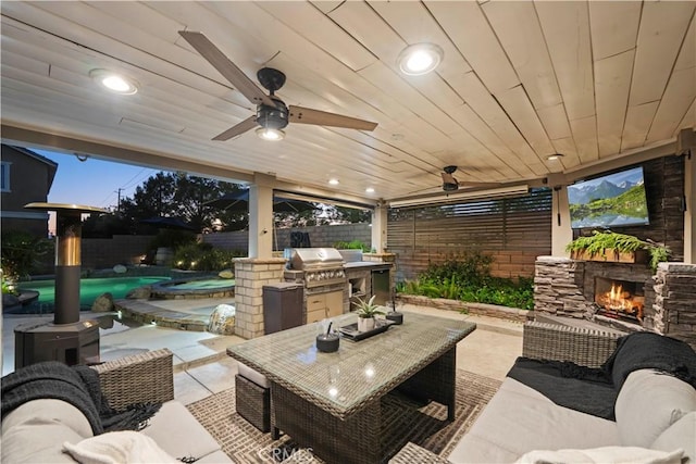 5239 Jade Ct, Lancaster, CA 93536 - fenced backyard featuring exterior kitchen, a patio, an outdoor living space with a fireplace, and a ceiling fan