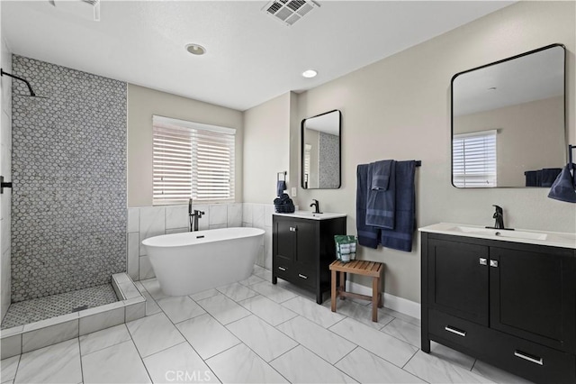 5239 Jade Ct, Lancaster, CA 93536 - full bathroom with walk in shower, a soaking tub, two vanities, tile walls, and recessed lighting