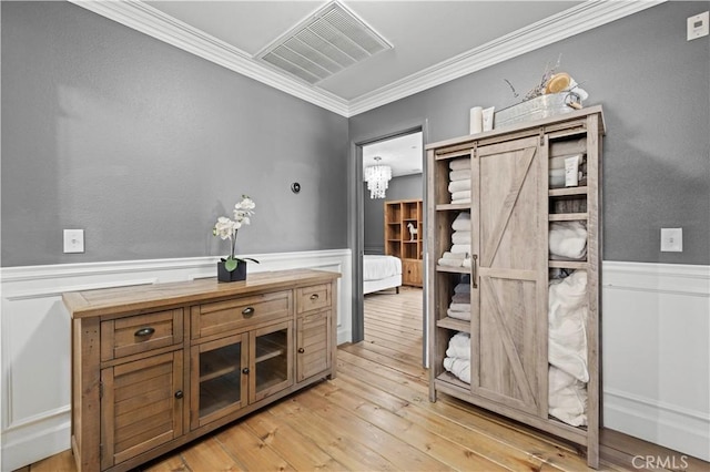 5239 Jade Ct, Lancaster, CA 93536 - bathroom with a wainscoted wall, ornamental molding, hardwood / wood-style flooring, and a chandelier