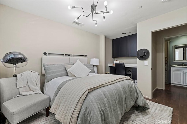 5239 Jade Ct, Lancaster, CA 93536 - bedroom with a chandelier, dark wood-style floors, and built in study area