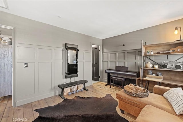 5239 Jade Ct, Lancaster, CA 93536 - living area with a decorative wall, light wood-type flooring, and wainscoting