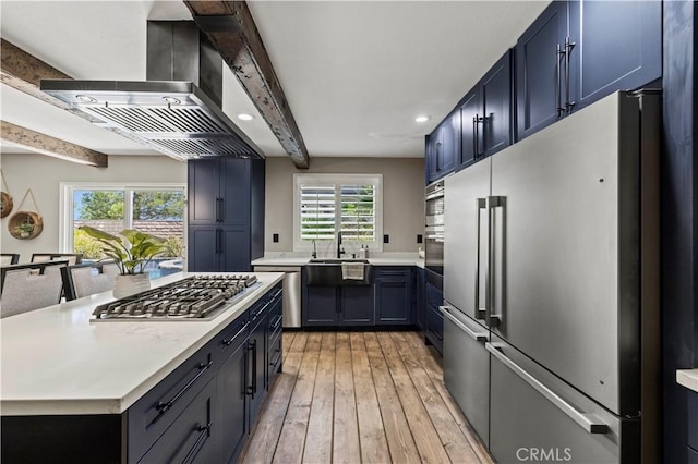 5239 Jade Ct, Lancaster, CA 93536 - kitchen featuring stainless steel appliances, wall chimney exhaust hood, light countertops, plenty of natural light, and recessed lighting