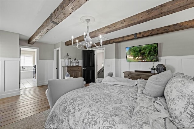 5239 Jade Ct, Lancaster, CA 93536 - bedroom with beam ceiling, a chandelier, a wainscoted wall, a decorative wall, and light wood-style flooring