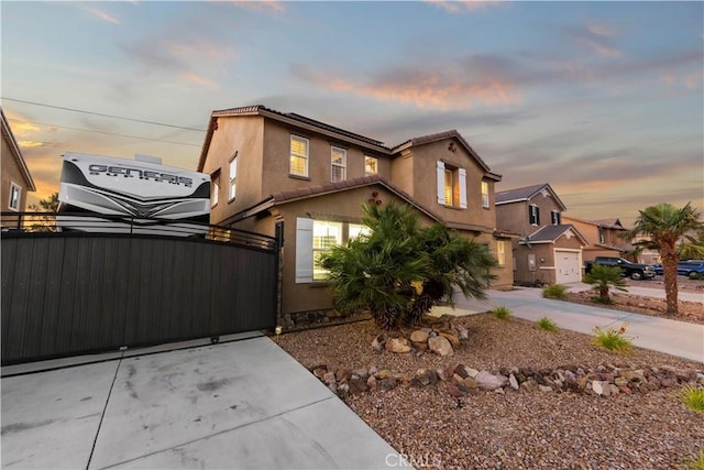 5239 Jade Ct, Lancaster, CA 93536 - mediterranean / spanish-style home with stucco siding, a gate, driveway, and a tile roof