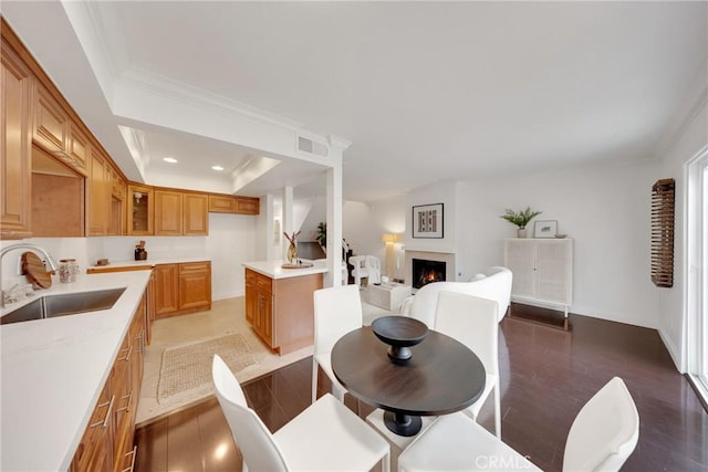 187 S Catalina Ave Unit 4, Pasadena, CA 91106 - dining room with wood finished floors, a lit fireplace, a tray ceiling, crown molding, and recessed lighting