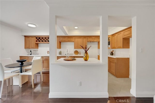 187 S Catalina Ave Unit 4, Pasadena, CA 91106 - kitchen featuring crown molding, tile patterned floors, light countertops, a sink, and a raised ceiling