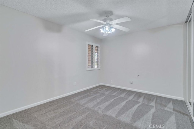 7551 Nada St, Downey, CA 90242 - empty room featuring a textured ceiling, carpet, baseboards, and ceiling fan