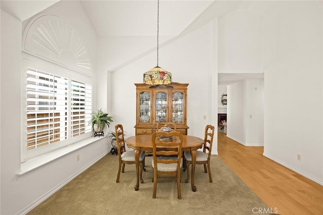 5787 Blackbird Ln, La Verne, CA 91750 - dining room with high vaulted ceiling, baseboards, and light wood-style flooring
