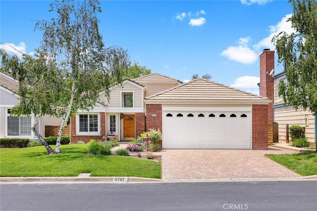 5787 Blackbird Ln, La Verne, CA 91750 - view of front facade with decorative driveway, a front lawn, an attached garage, brick siding, and a tiled roof