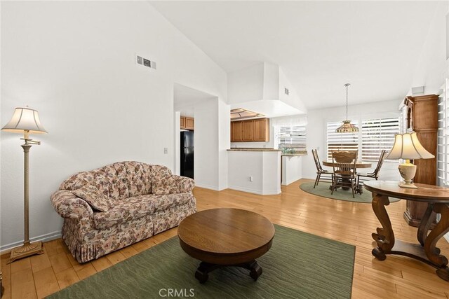 5787 Blackbird Ln, La Verne, CA 91750 - living room featuring light wood-style floors, vaulted ceiling, and baseboards