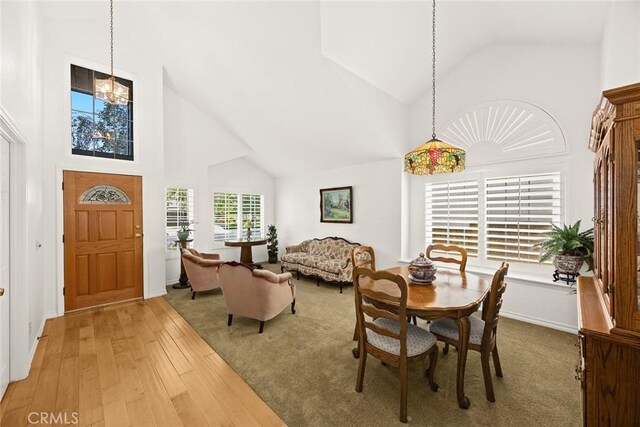 5787 Blackbird Ln, La Verne, CA 91750 - dining room with high vaulted ceiling, hardwood / wood-style floors, and a chandelier