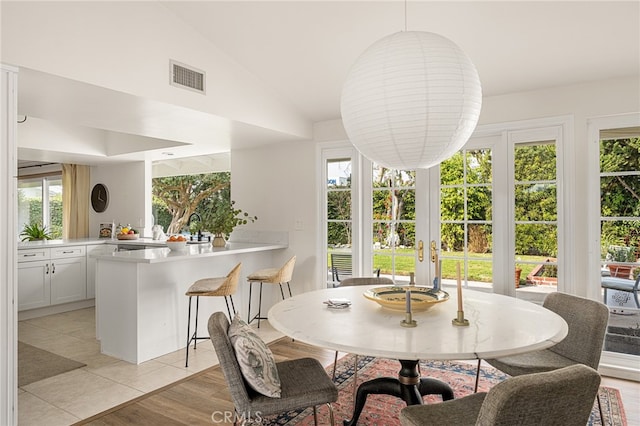 3231 Ruth Elaine Dr, Los Alamitos, CA 90720 - dining space with lofted ceiling and light tile patterned floors