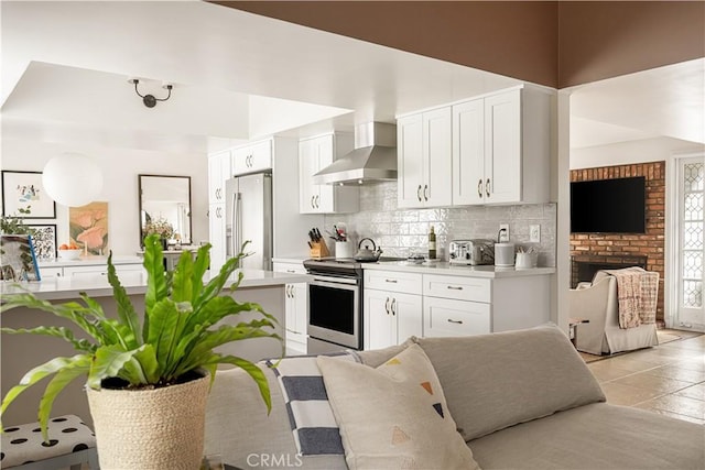 3231 Ruth Elaine Dr, Los Alamitos, CA 90720 - kitchen featuring stainless steel appliances, wall chimney exhaust hood, decorative backsplash, and white cabinets