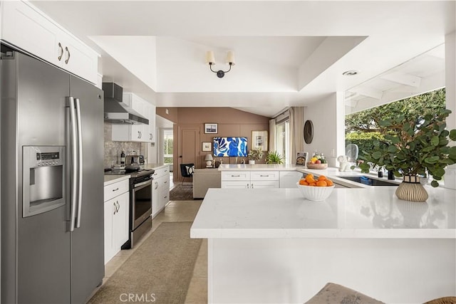 3231 Ruth Elaine Dr, Los Alamitos, CA 90720 - kitchen with stainless steel appliances, wall chimney exhaust hood, a peninsula, a sink, and light countertops