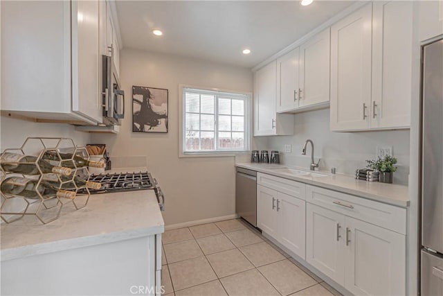 7704 Isis Ave, Los Angeles, CA 90045 - kitchen with appliances with stainless steel finishes, a sink, baseboards, white cabinets, and light tile patterned floors