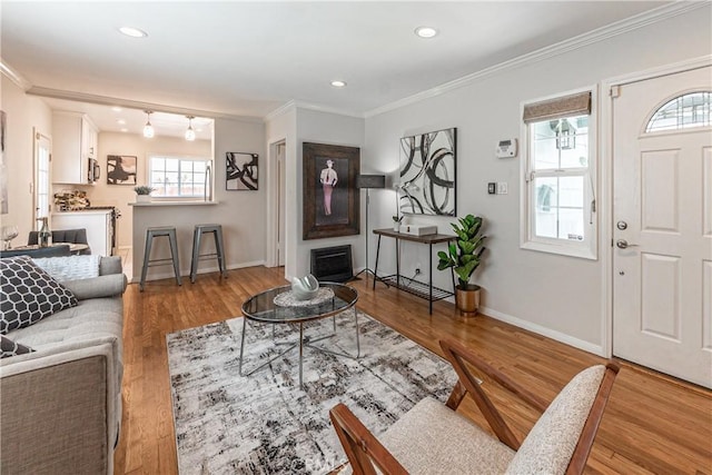 7704 Isis Ave, Los Angeles, CA 90045 - living area featuring baseboards, wood finished floors, ornamental molding, and recessed lighting