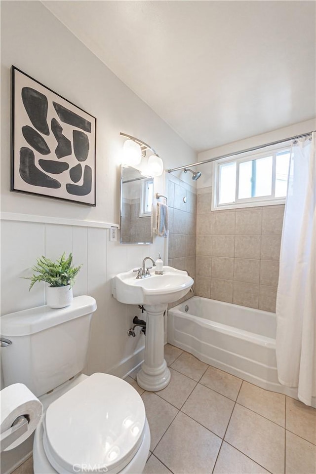 7704 Isis Ave, Los Angeles, CA 90045 - bathroom featuring toilet, tile patterned flooring, shower / tub combo with curtain, and wainscoting