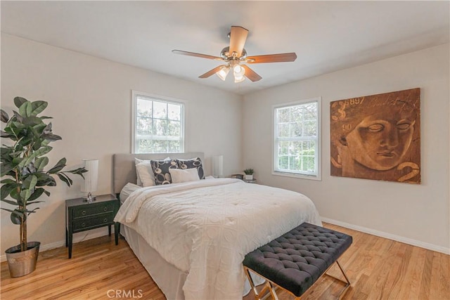 7704 Isis Ave, Los Angeles, CA 90045 - bedroom featuring multiple windows, light wood finished floors, baseboards, and ceiling fan
