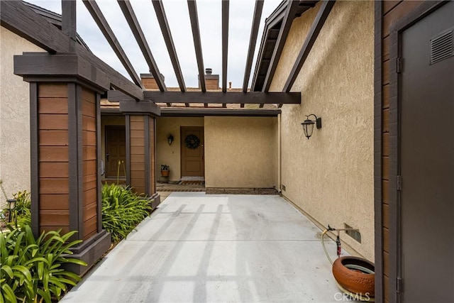 2726 Torrey Pine Dr Unit 12, Fullerton, CA 92835 - property entrance with stucco siding, a pergola, and a patio area
