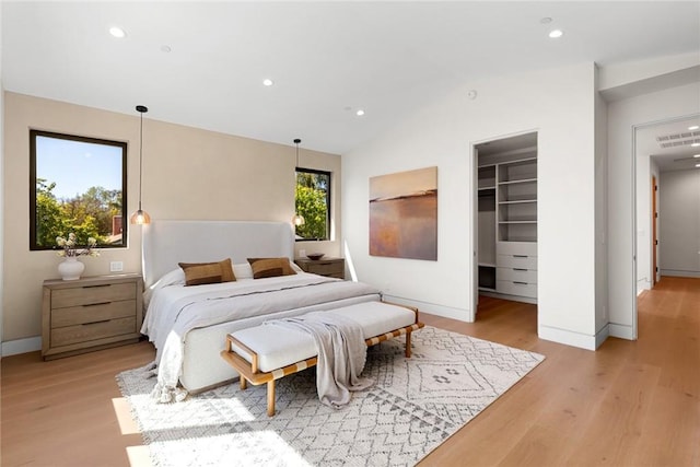 22640 Clarendon St, Woodland Hills, CA 91367 - bedroom with light wood-type flooring, a spacious closet, lofted ceiling, recessed lighting, and a closet