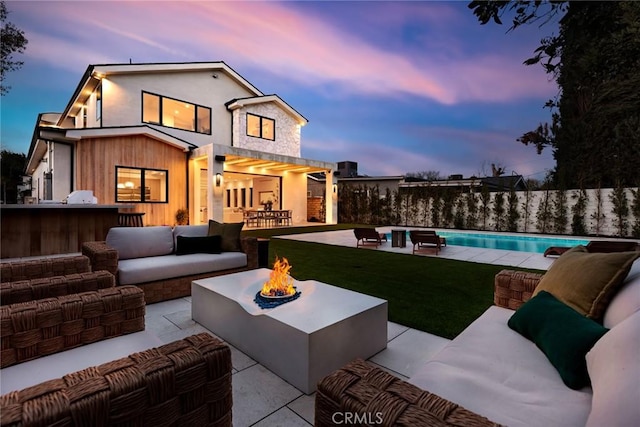22640 Clarendon St, Woodland Hills, CA 91367 - back of property featuring an outdoor living space with a fire pit and a patio