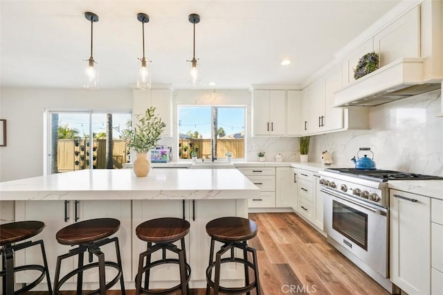 4326 Forest Ranch Rd, Oceanside, CA 92057 - kitchen featuring high end range, a kitchen island, tasteful backsplash, plenty of natural light, and recessed lighting
