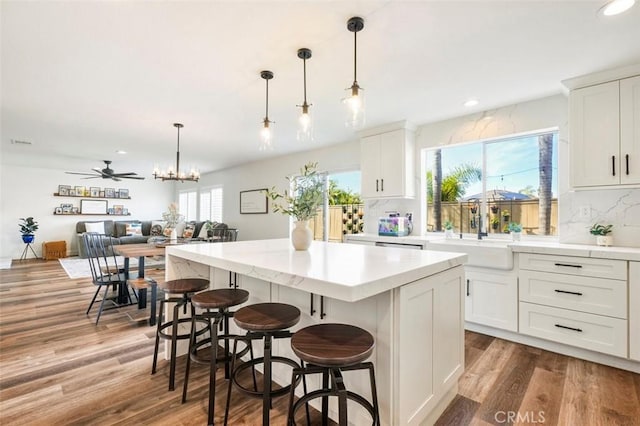 4326 Forest Ranch Rd, Oceanside, CA 92057 - kitchen featuring a sink, a kitchen island, wood finished floors, white cabinets, and recessed lighting