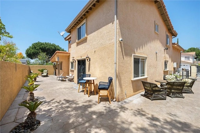 10610 Oak Tree Way, Sunland, CA 91040 - back of house featuring stucco siding, a fenced backyard, a patio, and outdoor dining space