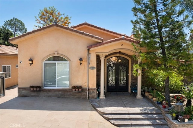 10610 Oak Tree Way, Sunland, CA 91040 - view of exterior entry with stucco siding and a tile roof