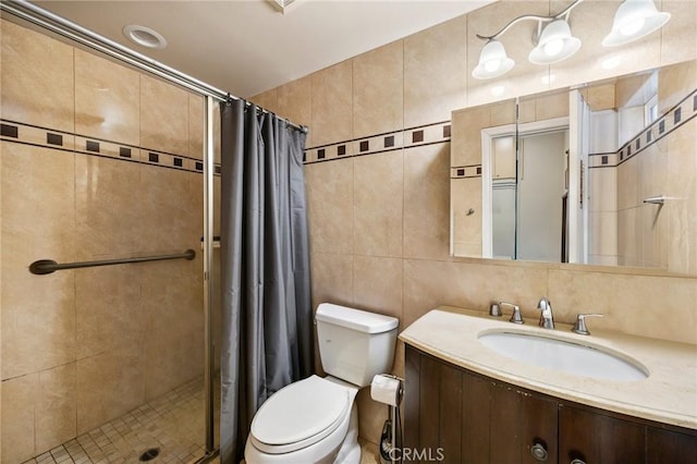 10610 Oak Tree Way, Sunland, CA 91040 - full bath featuring a stall shower, toilet, vanity, and tile walls