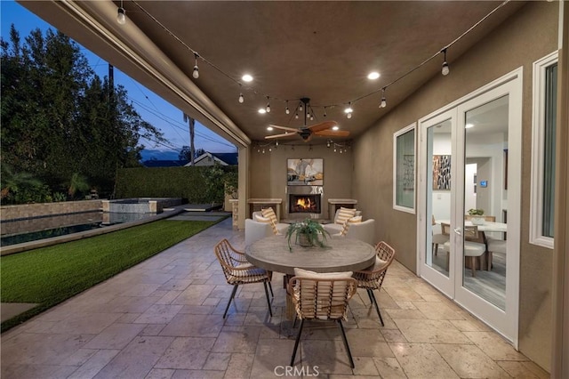3141 Hillrose Dr, Rossmoor, CA 90720 - fenced backyard featuring a lit fireplace, a patio area, ceiling fan, and outdoor dining space