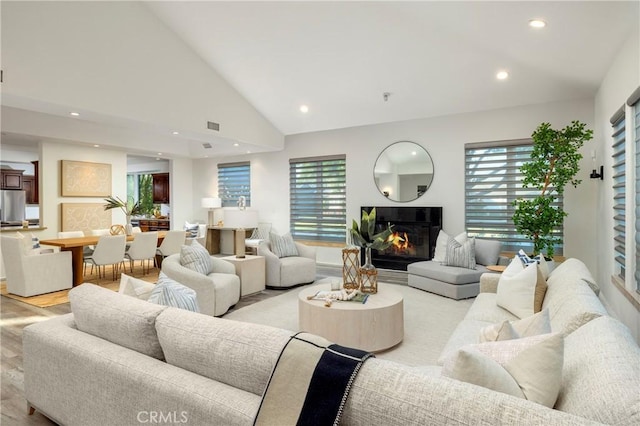 3141 Hillrose Dr, Rossmoor, CA 90720 - living room featuring light wood-style flooring, a glass covered fireplace, healthy amount of natural light, recessed lighting, and lofted ceiling