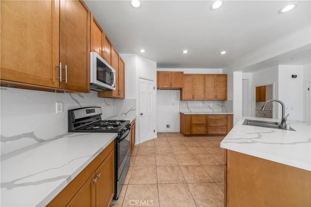 1568 Burns Ln, San Jacinto, CA 92335 - kitchen featuring white microwave, range with gas cooktop, a sink, brown cabinetry, and recessed lighting