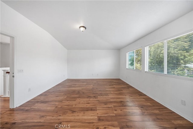 1568 Burns Ln, San Jacinto, CA 92335 - spare room featuring lofted ceiling, wood finished floors, and baseboards