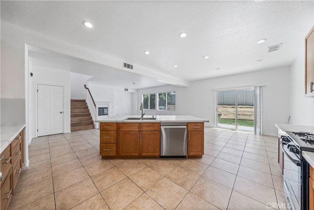 1568 Burns Ln, San Jacinto, CA 92335 - kitchen featuring dishwasher, a sink, gas range, brown cabinets, and light countertops
