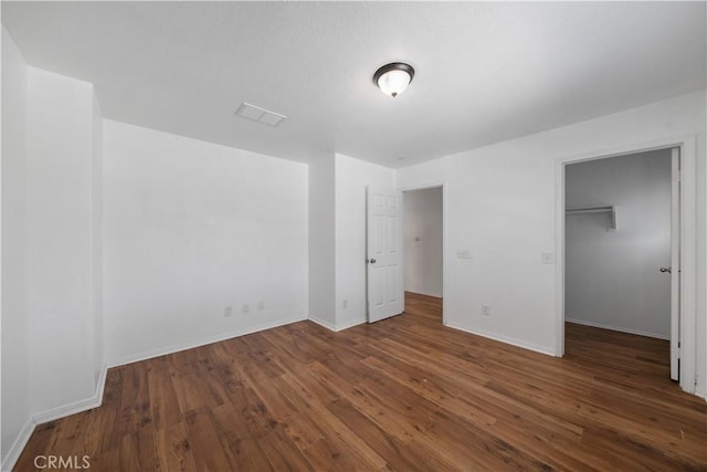 1568 Burns Ln, San Jacinto, CA 92335 - unfurnished bedroom with wood finished floors, baseboards, a spacious closet, and a closet