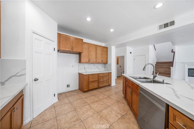 1568 Burns Ln, San Jacinto, CA 92335 - kitchen with stainless steel dishwasher, a sink, brown cabinets, recessed lighting, and light stone counters
