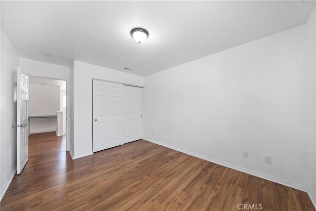 1568 Burns Ln, San Jacinto, CA 92335 - unfurnished bedroom with wood finished floors, baseboards, and a closet