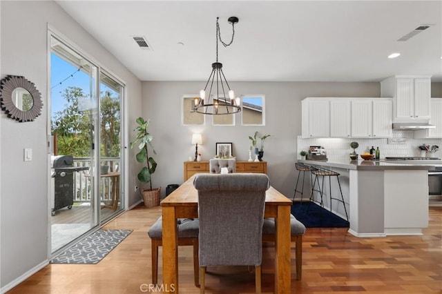 103 Corte Tierra Bella, San Clemente, CA 92673 - dining area with light wood finished floors, a chandelier, recessed lighting, and baseboards